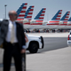A member of the secret service stands next to President Donald Trump’s limo as unused American Airline jets are seen at Phoenix Sky Harbor Airport during his first trip since widespread COVID-19 related lockdowns went into effect May 5, 2020, in Phoenix, Arizona.